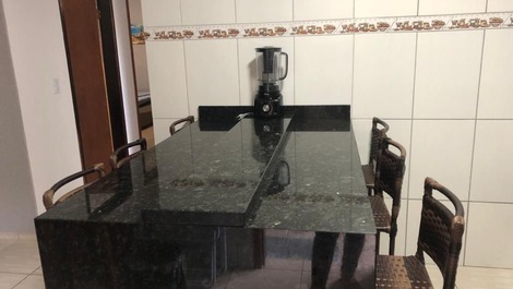 Mesa de granito e 6 banquetas na cozinha. 