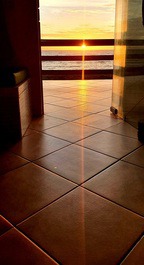 Vista do sol nascendo sentado no sofá da sala.