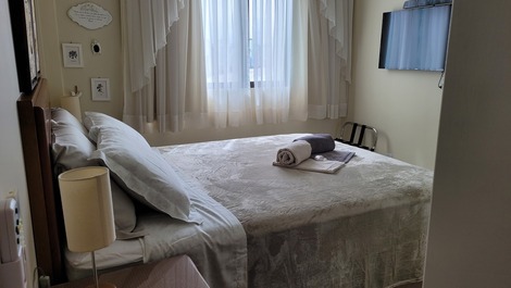 Suíte com cama queen e tv smart