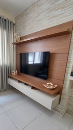 Smart tv de 50", montada sobre o painel, conectada ao wi-fi e com assinatura prime da amazon.