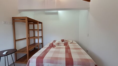 House with balcony and barbecue in gated community.