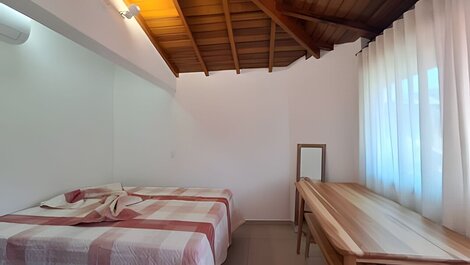 House with balcony and barbecue in gated community.