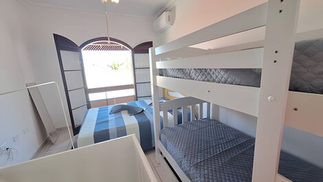 House with balcony and barbecue in gated community.