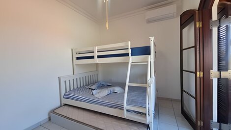 House with balcony and barbecue in gated community.