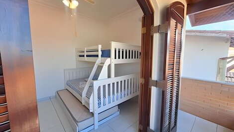 House with balcony and barbecue in gated community.