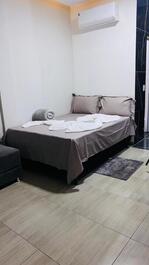 Studio apartment, cozy, bedroom, kitchen, bathroom.